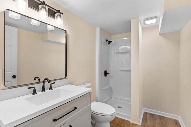 1345 E Deshler Ave, Columbus, OH 43206 - bathroom featuring toilet, wood finished floors, walk in shower, and vanity