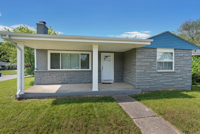 1345 E Deshler Ave, Columbus, OH 43206 - ranch-style house featuring stone siding, covered porch, a front lawn, and a chimney