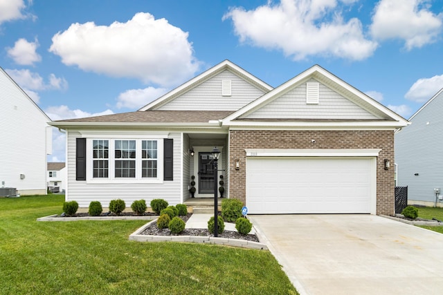 1333 Andy Way, Pataskala, OH 43062 - view of front of home featuring a front yard, brick siding, concrete driveway, and an attached garage
