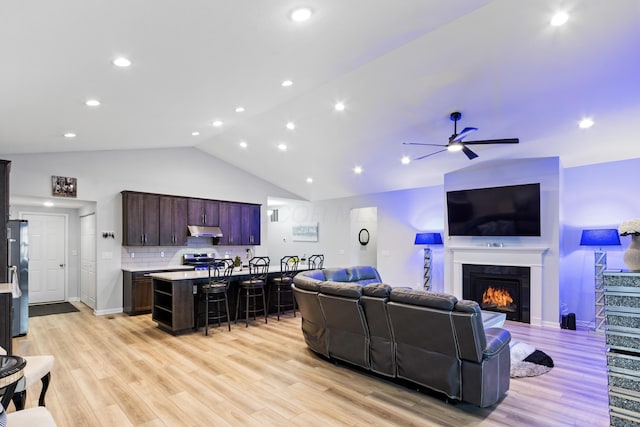 1333 Andy Way, Pataskala, OH 43062 - living room featuring a lit fireplace, a ceiling fan, light wood-style flooring, high vaulted ceiling, and recessed lighting