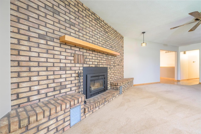20 Snider Rd, New Carlisle, OH 45344 - unfurnished living room featuring a ceiling fan, a brick fireplace, baseboards, and carpet flooring