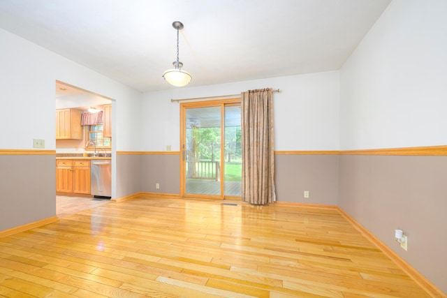 20 Snider Rd, New Carlisle, OH 45344 - unfurnished room with light wood finished floors, baseboards, and a sink