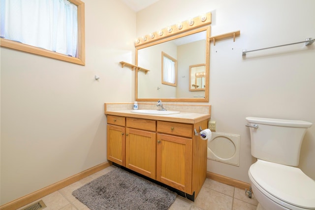 20 Snider Rd, New Carlisle, OH 45344 - bathroom featuring toilet, vanity, tile patterned floors, and baseboards