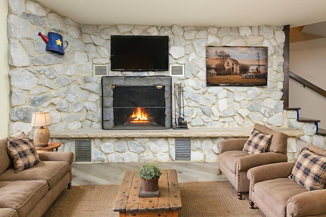 20 Snider Rd, New Carlisle, OH 45344 - living area with a lit fireplace and wood finished floors