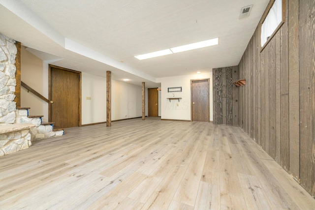 20 Snider Rd, New Carlisle, OH 45344 - below grade area featuring light wood-style flooring, wood walls, and stairway
