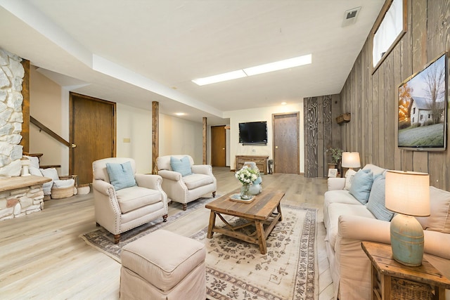 20 Snider Rd, New Carlisle, OH 45344 - living area with light wood-type flooring, stairs, and wood walls