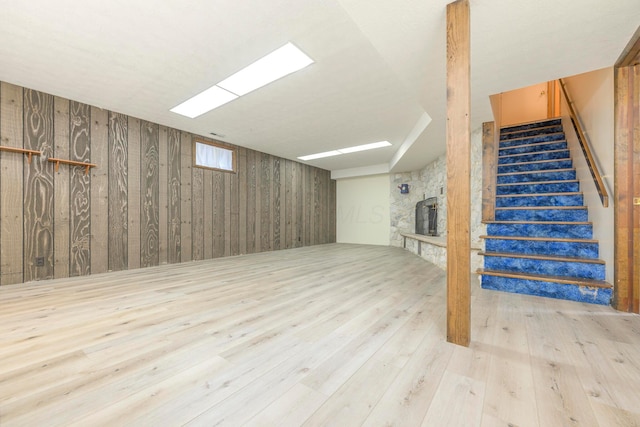 20 Snider Rd, New Carlisle, OH 45344 - below grade area featuring stairway, hardwood / wood-style floors, wooden walls, and a stone fireplace
