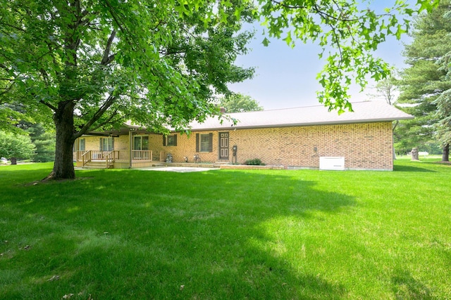 20 Snider Rd, New Carlisle, OH 45344 - rear view of house featuring a lawn and brick siding