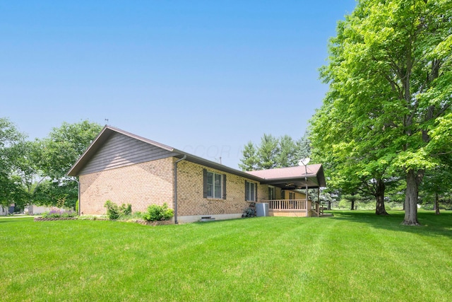 20 Snider Rd, New Carlisle, OH 45344 - view of property exterior with brick siding, a lawn, and a ceiling fan