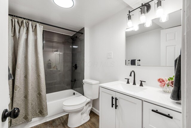 3944 Ardath Rd, Columbus, OH 43228 - bathroom with wood finished floors, vanity, toilet, shower / tub combo, and baseboards