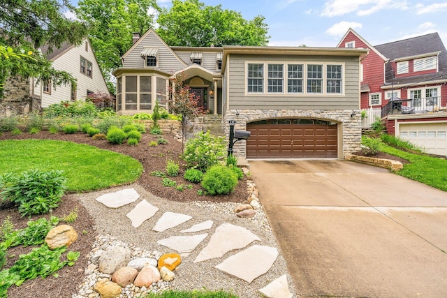 137 E Torrence Rd, Columbus, OH 43214 - view of front of property with stone siding, a sunroom, a garage, driveway, and a chimney