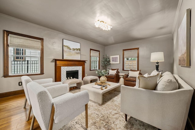 137 E Torrence Rd, Columbus, OH 43214 - living area with plenty of natural light, light wood finished floors, crown molding, a fireplace, and baseboards