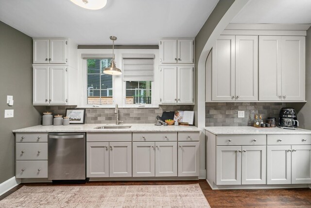 137 E Torrence Rd, Columbus, OH 43214 - kitchen with dishwasher, a sink, backsplash, dark wood-type flooring, and decorative light fixtures