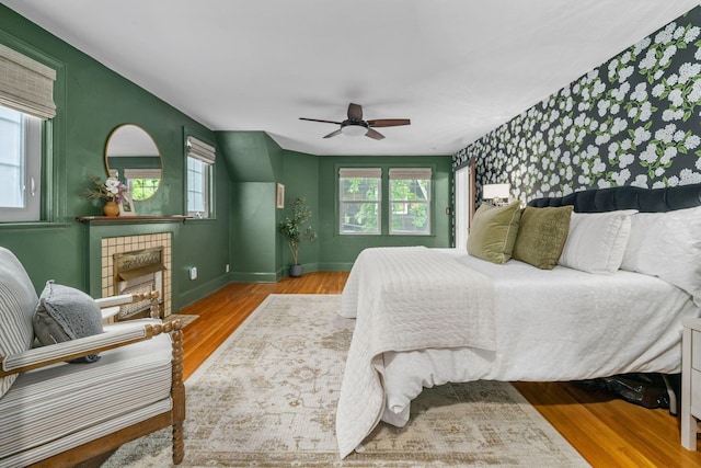 137 E Torrence Rd, Columbus, OH 43214 - bedroom with an accent wall, wood finished floors, baseboards, a fireplace, and a ceiling fan