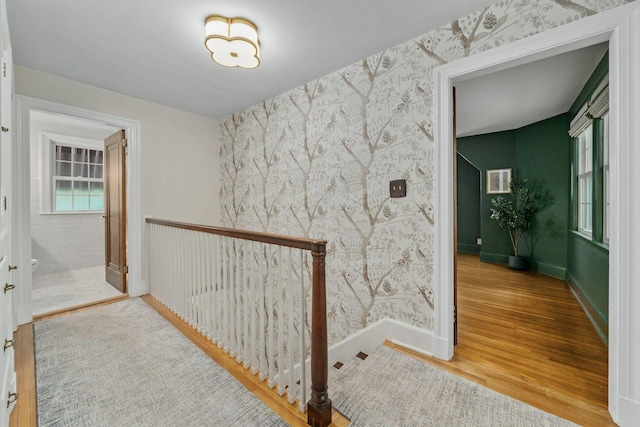 137 E Torrence Rd, Columbus, OH 43214 - hall featuring wallpapered walls, wood finished floors, baseboards, an upstairs landing, and an accent wall