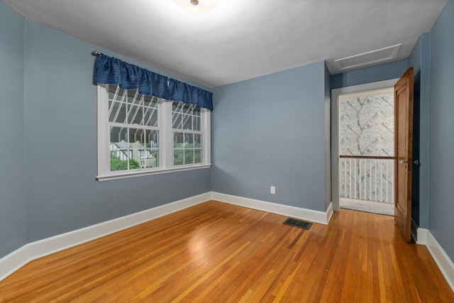 137 E Torrence Rd, Columbus, OH 43214 - spare room featuring wood finished floors, baseboards, and attic access