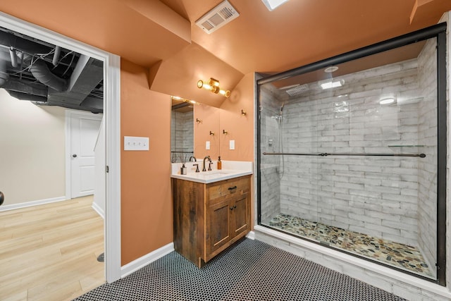 137 E Torrence Rd, Columbus, OH 43214 - full bathroom featuring vanity, a shower stall, baseboards, and wood finished floors