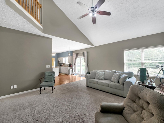6048 Trent Ct, Lewis Center, OH 43035 - living area featuring carpet flooring, a ceiling fan, a textured ceiling, high vaulted ceiling, and baseboards