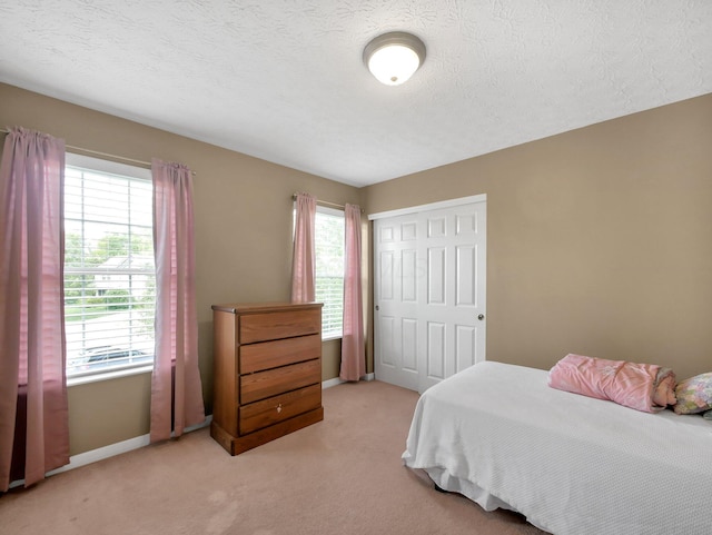6048 Trent Ct, Lewis Center, OH 43035 - bedroom with a closet, light colored carpet, baseboards, and a textured ceiling