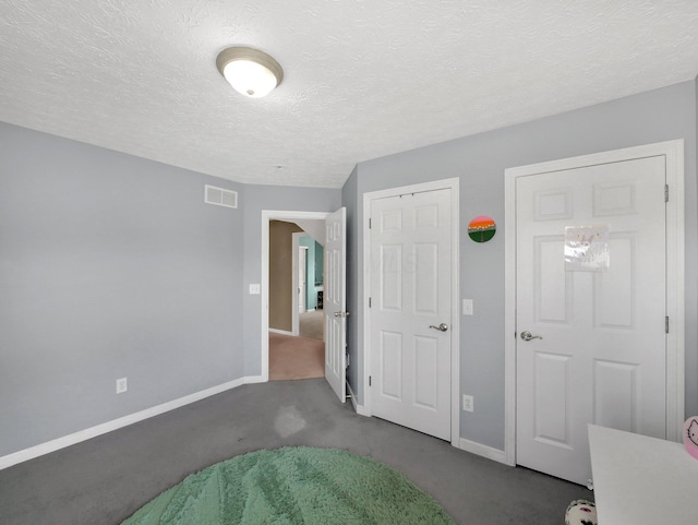 6048 Trent Ct, Lewis Center, OH 43035 - unfurnished bedroom with dark colored carpet, baseboards, and a textured ceiling