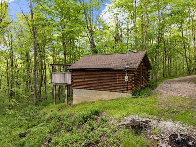 26975 Chapel Ridge Rd, South Bloomingville, OH 43152 - view of side of property featuring log exterior, a deck, and a shingled roof