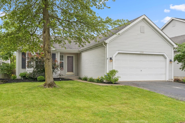 6389 Riverstone Dr, Columbus, OH 43228 - view of front of house featuring asphalt driveway, an attached garage, a front yard, and a shingled roof