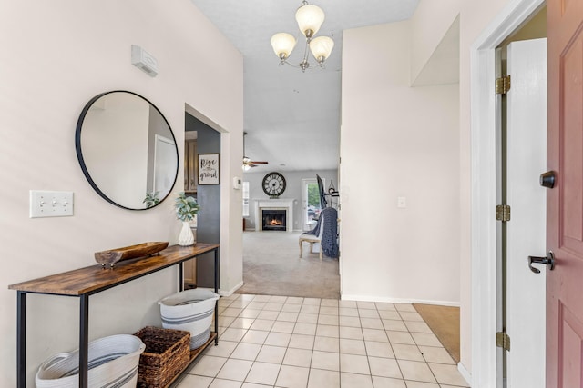 6389 Riverstone Dr, Columbus, OH 43228 - hallway featuring light colored carpet, light tile patterned floors, and a chandelier