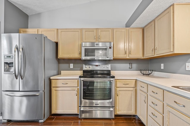 6389 Riverstone Dr, Columbus, OH 43228 - kitchen with stainless steel appliances, light brown cabinets, light countertops, and a textured ceiling