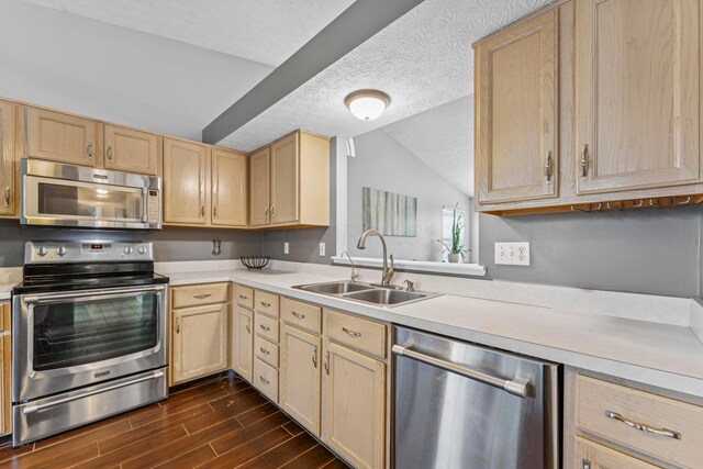 6389 Riverstone Dr, Columbus, OH 43228 - kitchen featuring appliances with stainless steel finishes, light brown cabinetry, a sink, light countertops, and dark wood finished floors