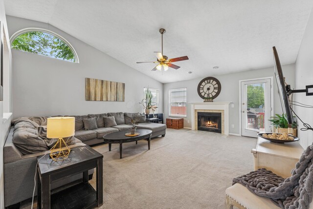 6389 Riverstone Dr, Columbus, OH 43228 - living area with ceiling fan, light carpet, a tile fireplace, and high vaulted ceiling