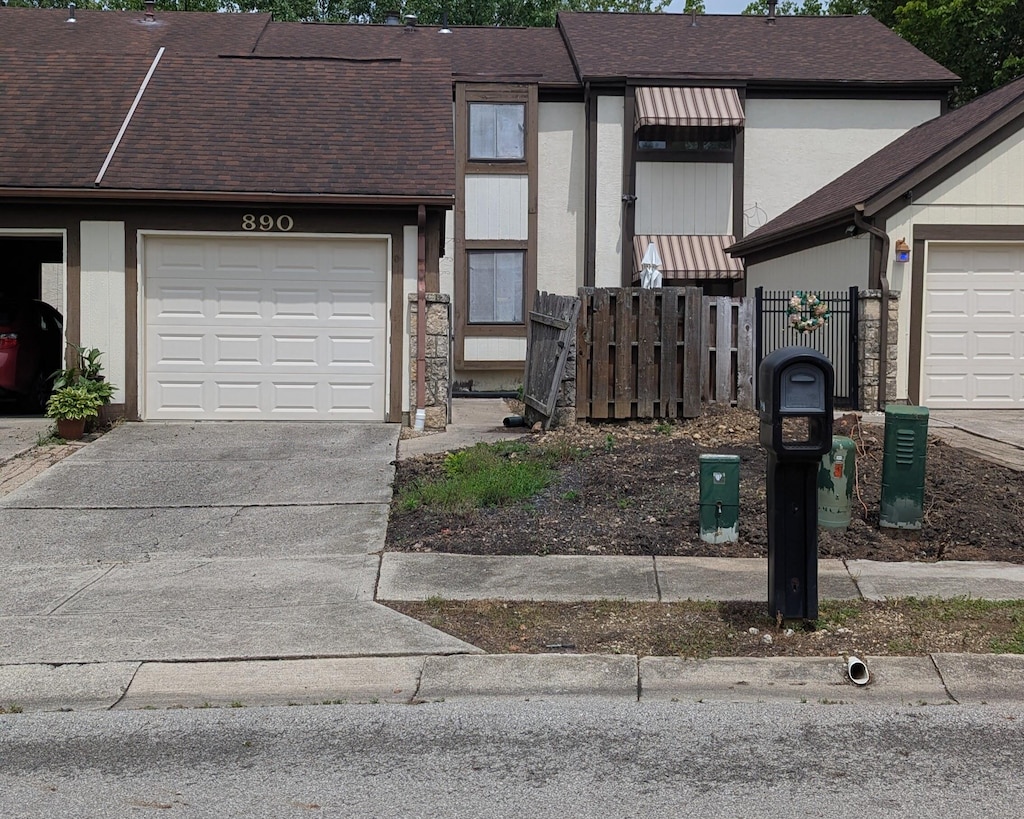 890 Tamara Dr N, Columbus, OH 43230 - multi unit property featuring an attached garage, driveway, and a shingled roof