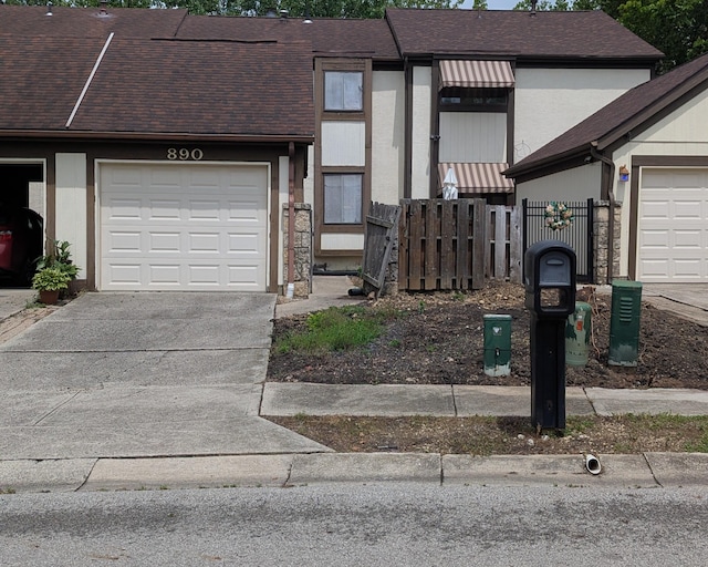 890 Tamara Dr N, Columbus, OH 43230 - multi unit property featuring an attached garage, driveway, and a shingled roof