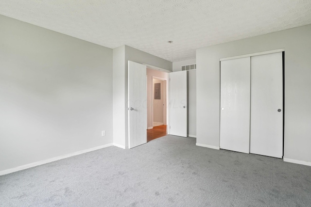 4655 Parrau Dr Unit 66A, Columbus, OH 43228 - unfurnished bedroom with carpet, a closet, baseboards, electric panel, and a textured ceiling