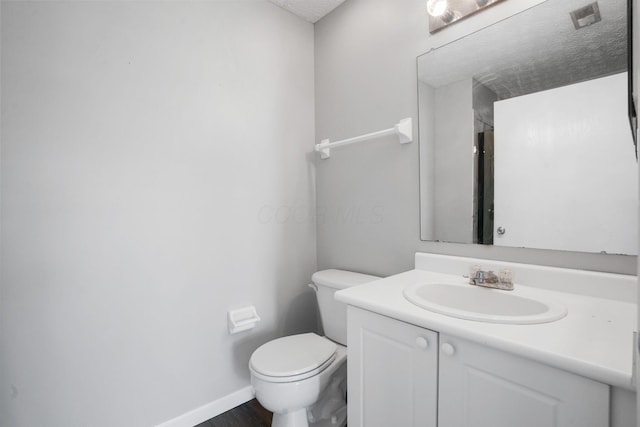 4655 Parrau Dr Unit 66A, Columbus, OH 43228 - bathroom with toilet, vanity, baseboards, wood finished floors, and a textured ceiling