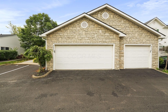 4655 Parrau Dr Unit 66A, Columbus, OH 43228 - view of front of home with stone siding and asphalt driveway