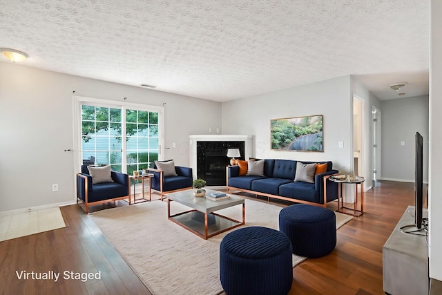 4655 Parrau Dr Unit 66A, Columbus, OH 43228 - living area with dark wood-style flooring, a textured ceiling, baseboards, and a high end fireplace