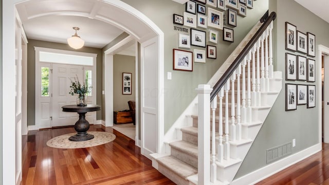 122 Boulder Ct, Granville, OH 43023 - foyer entrance with arched walkways, wood-type flooring, and baseboards