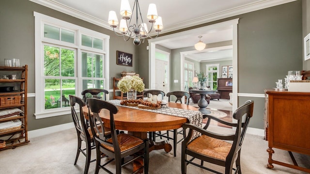 122 Boulder Ct, Granville, OH 43023 - dining area with light colored carpet, ornamental molding, a chandelier, and baseboards