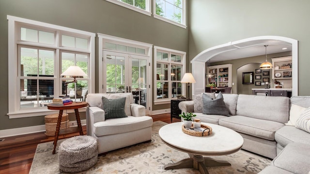 122 Boulder Ct, Granville, OH 43023 - living room with arched walkways, wood finished floors, french doors, a high ceiling, and baseboards