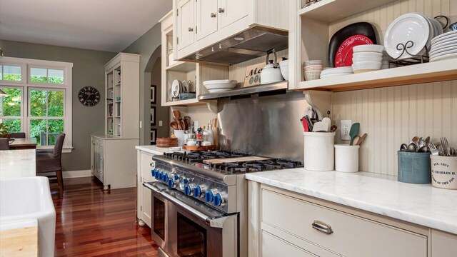 122 Boulder Ct, Granville, OH 43023 - kitchen with high end stove, open shelves, dark wood-style floors, white cabinets, and under cabinet range hood