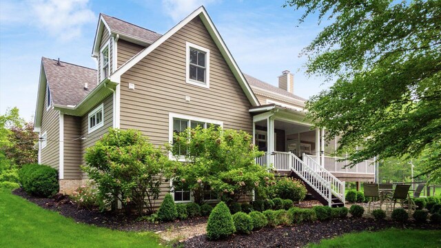 122 Boulder Ct, Granville, OH 43023 - view of home's exterior featuring stairs, a shingled roof, a chimney, and a yard