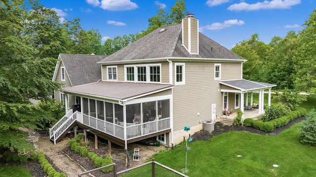 122 Boulder Ct, Granville, OH 43023 - back of house with a sunroom, a lawn, roof with shingles, and a chimney