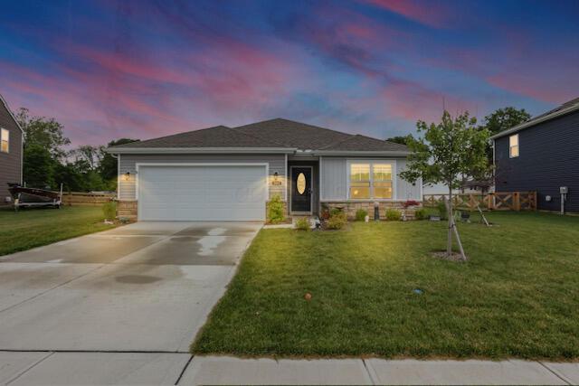 351 Trinity Way W, Newark, OH 43055 - view of front facade featuring a garage, driveway, and stone siding