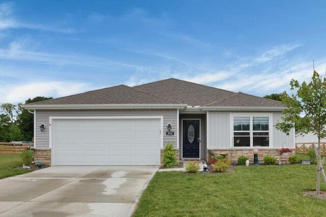 351 Trinity Way W, Newark, OH 43055 - view of front of home with stone siding, concrete driveway, a garage, and a front yard