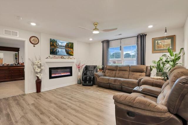 351 Trinity Way W, Newark, OH 43055 - living area featuring a ceiling fan, wood finished floors, a glass covered fireplace, recessed lighting, and baseboards
