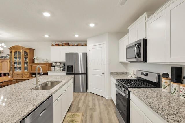 351 Trinity Way W, Newark, OH 43055 - kitchen with appliances with stainless steel finishes, a sink, white cabinetry, light wood-style floors, and light stone counters