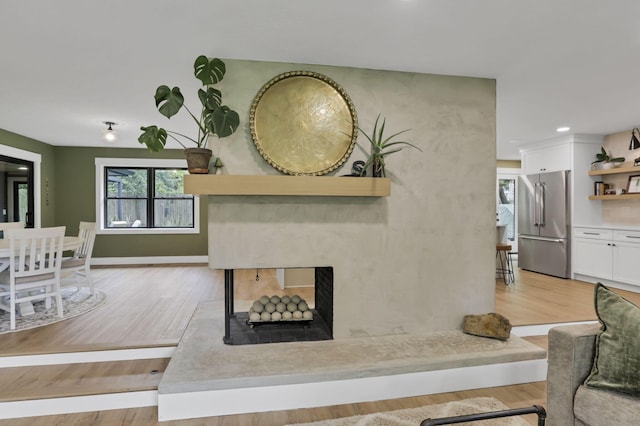 29 Pocono Rd, Columbus, OH 43235 - living room with light wood finished floors, a premium fireplace, baseboards, and recessed lighting