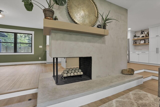 29 Pocono Rd, Columbus, OH 43235 - living room featuring light wood-style flooring, a multi sided fireplace, and baseboards