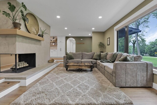29 Pocono Rd, Columbus, OH 43235 - living area with recessed lighting, arched walkways, light wood-style floors, and a high end fireplace