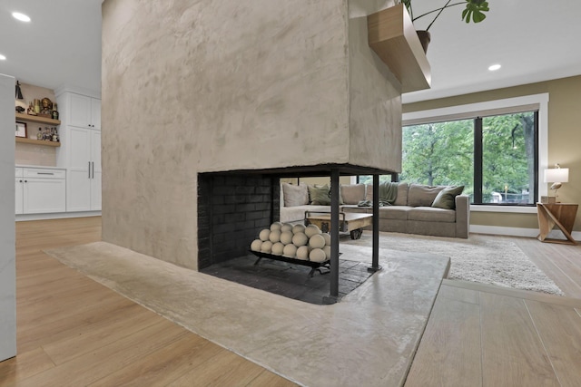 29 Pocono Rd, Columbus, OH 43235 - living area with wood finished floors, a multi sided fireplace, recessed lighting, and baseboards